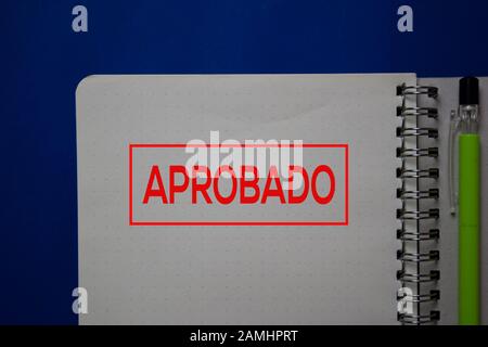 Aprobado write on a book spanish language isolated on blue background. Stock Photo