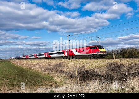 Virgin Trains on the East Coast Mainline at Swayfield, Lincolnshire heading South. Stock Photo
