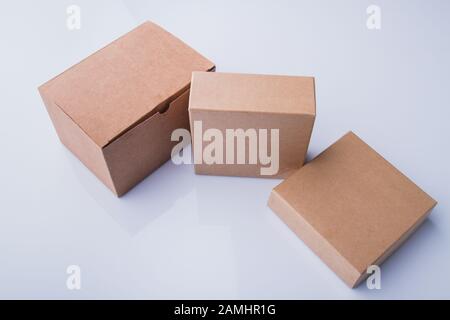Three different beige cardboard boxes. Stock Photo