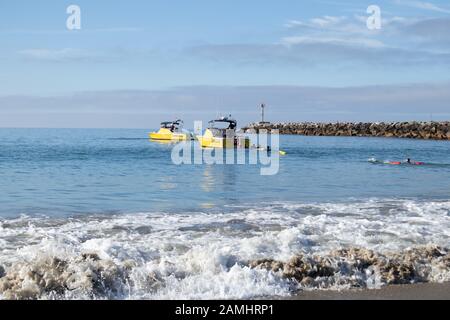 Junior Life Guards swimming to boat at Corona del Mar State Beach Newport Beach Southern California USA Stock Photo