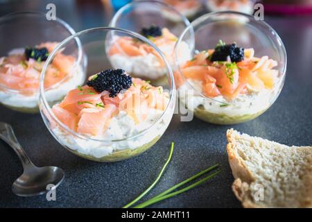 verrine salmon lumpfish egg fresh cheese and avocado bed in the kitchen Stock Photo