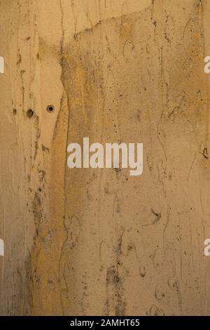 The wall is white with cracked paint, rusty metal and bullet holes. Creative vintage background Stock Photo