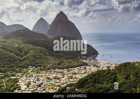 View down to Soufriere, with the twin peaks of the Piton mountains behind, Saint Lucia, West Indies, Caribbean Stock Photo