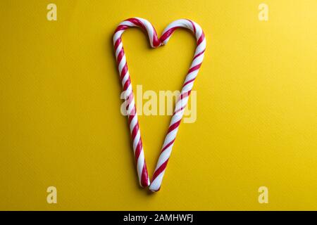 Peppermint candy canes on a yellow background Stock Photo