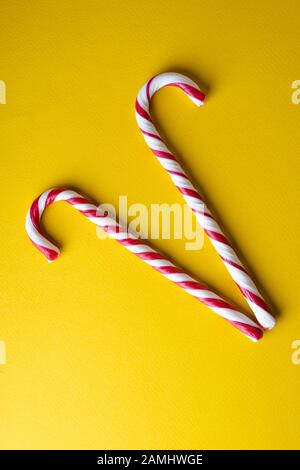Peppermint candy canes on a yellow background Stock Photo