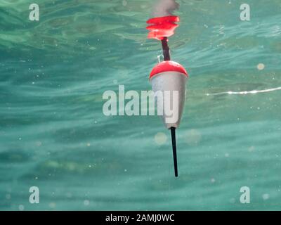 Polystyrene fishing float pulled underwater Stock Photo
