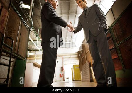 Low angle view of two businessmen shaking hands. Stock Photo