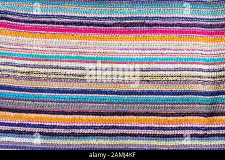 Multicolored horizontal bright strips of woven material. Background texture with copy space Stock Photo