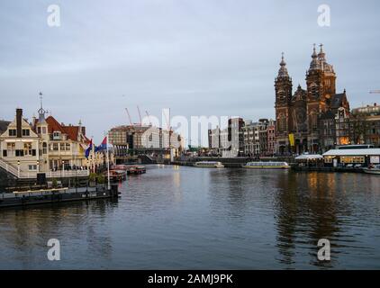 Amsterdam Central station and boats on the Canal Stock Photo