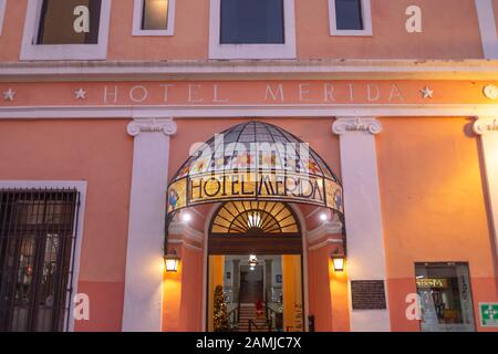 The facade of the Hotel Merida at dusk on Calle 60 in Merida, Yucatan, Mexico. Stock Photo