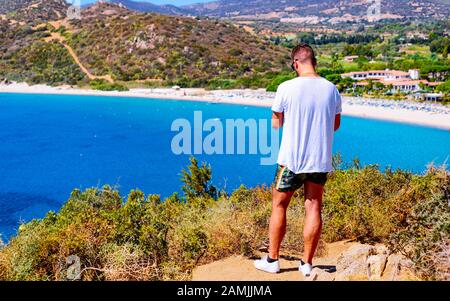 Man looking at beach near Mediterranean Sea in Villasimius Cagliari reflex Stock Photo