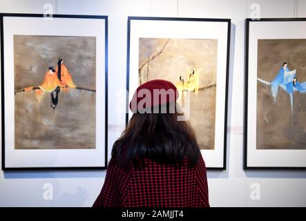 (200114) -- SAN FRANCISCO, Jan. 14, 2020 (Xinhua) -- A visitor views artwork at an art exhibition of the opening of the 2020 'Happy Chinese New Year' program in San Francisco, the United States, Jan. 12, 2020. An art exhibition in the San Francisco Bay Area on Sunday marked the opening of the 2020 'Happy Chinese New Year' program, aimed at sharing traditional Chinese New Year traditions with the world. The exhibition, entitled 'Voice of Spring,' consists of more than 50 paintings by artists from the United States, China and Britain. The artworks, all featuring flowers, will be on display Stock Photo