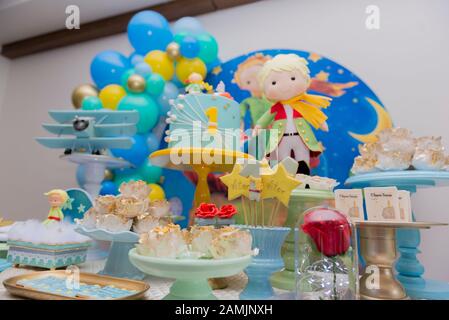Sweet table and big cake for first birthday. Candy bar with a lot of candies, cupcakes and sweet cakes. Little prince theme party. Close up of decor p Stock Photo