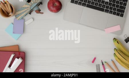 Overhead shot of professional artist workspace with copy space, laptop, stationery, office supplies, fruits and coloured pencils on white desk backgro Stock Photo