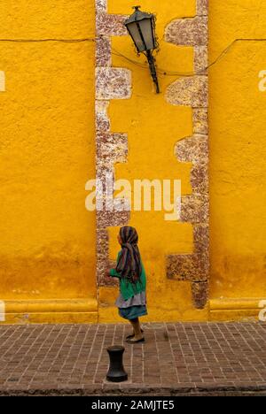 Elderly Mexican indigenois woman walking down a street in San Miguel de Allende, Mexico Stock Photo