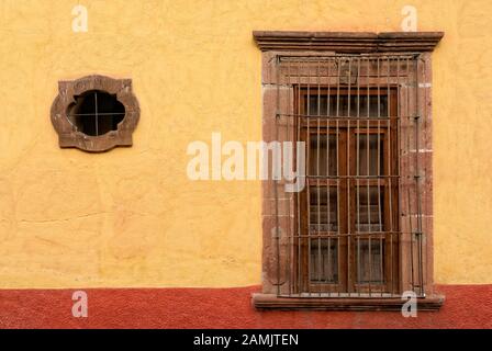 Windows in the colorful wall of a Spanish colonial house in San Miguel de Allende, Mexico Stock Photo