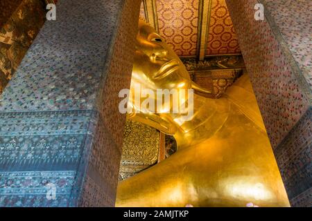 The reclining golden Buddha  statue is also known as 'The Nirvana Buddha' or the sleeping Buddha which means the entry of Buddha to Nirvana. Stock Photo