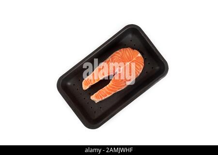 raw salmon steak in the package, isolated on white background. Stock Photo