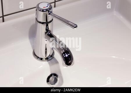 new faucet in bathroom with parts of sink Stock Photo