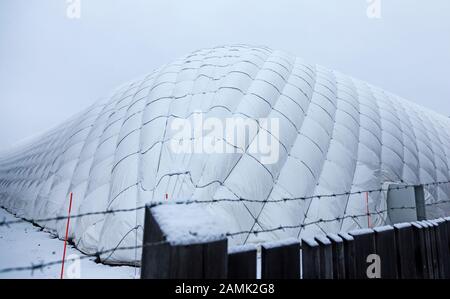 Umea, Norrland Sweden - December 20, 2019: large football tent behind barbed wire on which it snowed Stock Photo