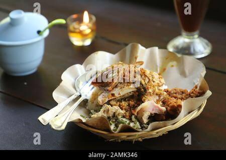 Nasi Campur Babi Guling. Balinese rice dish of roast pork with other pork and vegetable side dishes. Stock Photo