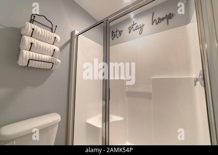 Neatly rolled white towels in a wall holder Stock Photo