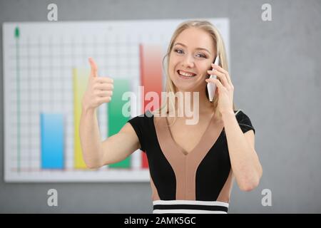 Blond woman broker buys and sells securities and currency Stock Photo