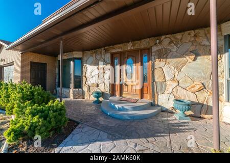 Modern house with paved patio and circular steps Stock Photo