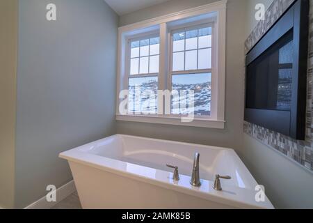 Small compact modern bathroom with deep tub Stock Photo