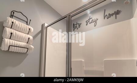 Panorama Neatly rolled white towels in a wall holder Stock Photo