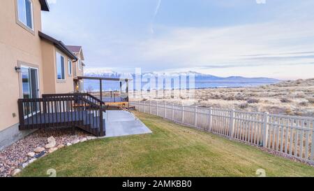Panorama Neat landscaped garden with white picket fence Stock Photo
