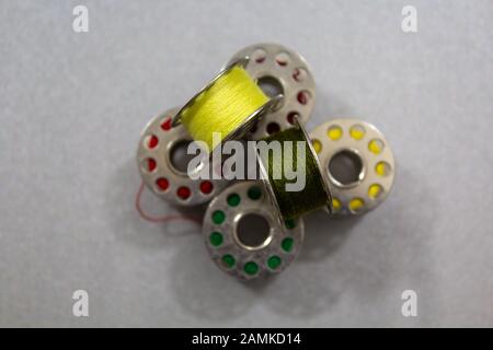 Yarn coils of a sewing machine with different yarn colours Stock Photo