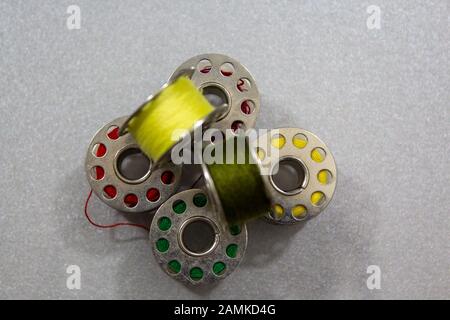 Yarn coils of a sewing machine with different yarn colours Stock Photo