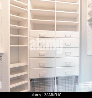 Square frame Fully fitted empty white walk-in wardrobe bright interior Stock Photo