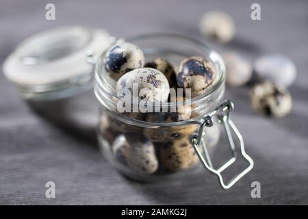 quail eggs in a glass jar with willow. Easter decoration of the kitchen Stock Photo