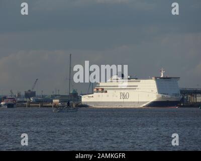 Yacht Cat Zero on The River Humber estuary near the P and O North Sea Ferry 'Pride of Rotterdam' at her berth near King George Dock in east Hull, UK Stock Photo