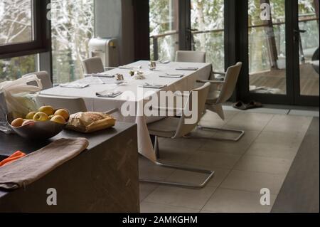 A dining room with served table, focus in the foreground Stock Photo