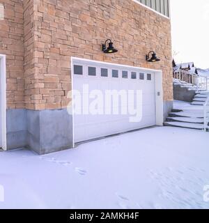 Square frame Fresh snow in winter on driveway to garages Stock Photo