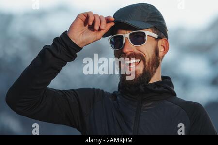 Adventurous explorer man with beard and glasses smiling Stock Photo