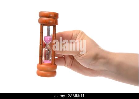Hand holding an hourglass isolated on white background Stock Photo