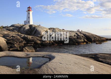 the famous lighthouse in the fishing village Peggys Cove with reflection in the water, St Margarets Bay, Lighthouse Route, Highway 333, Nova Scotia, Atlantic Canada. [automated translation] Stock Photo