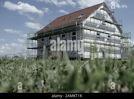 Scaffolded residential house under construction in the industrial area West in Maisach. [automated translation] Stock Photo