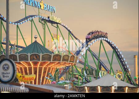 Oktoberfest 2012 Colourfully illuminated roller coaster in front