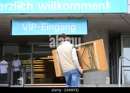 A new emergency accommodation for asylum seekers will be set up in the guest of honour area of the Munich Olympic Stadium. In the picture a foldable wooden table is delivered. [automated translation] Stock Photo