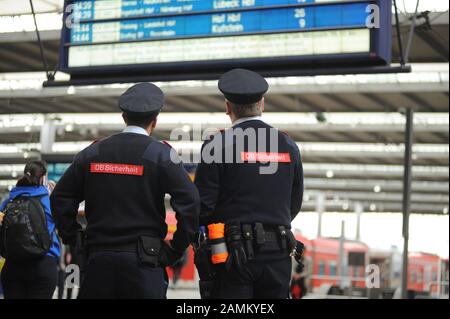 A strike by the train drivers' union GDL has paralyzed the S-Bahn and long-distance trains in Munich to a large extent. The picture shows two DB Sicherheit employees in front of a display board at the main station with train cancellations in the main station. [automated translation] Stock Photo