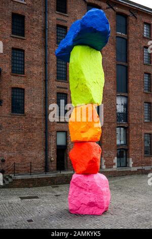 'Liverpool Mountain' gravity-deying sculpture by Swiss artist Ugo Rondinone sits in Mermaid Courtyard outside the Tate Liverpool at Royal Albert Dock. Stock Photo