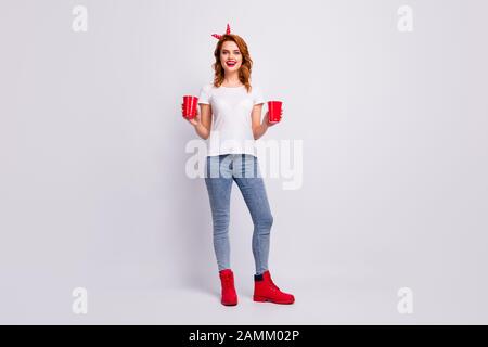 Full length body size view of her she nice attractive lovely fashionable glad cheerful cheery girl holding in hands punch cups having fun weekend Stock Photo