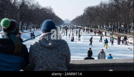 Ice skaters and curling enthusiasts enjoy themselves on the frozen Nymphenburg Castle Canal. [automated translation] Stock Photo
