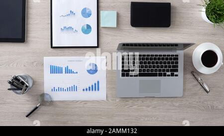 Open laptop lying on desk in office, business concept, top view of workplace Stock Photo
