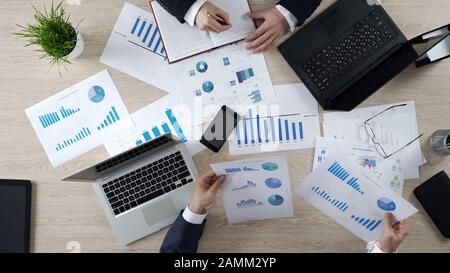 Analysts preparing notes to future on-line presentation learning statistics Stock Photo